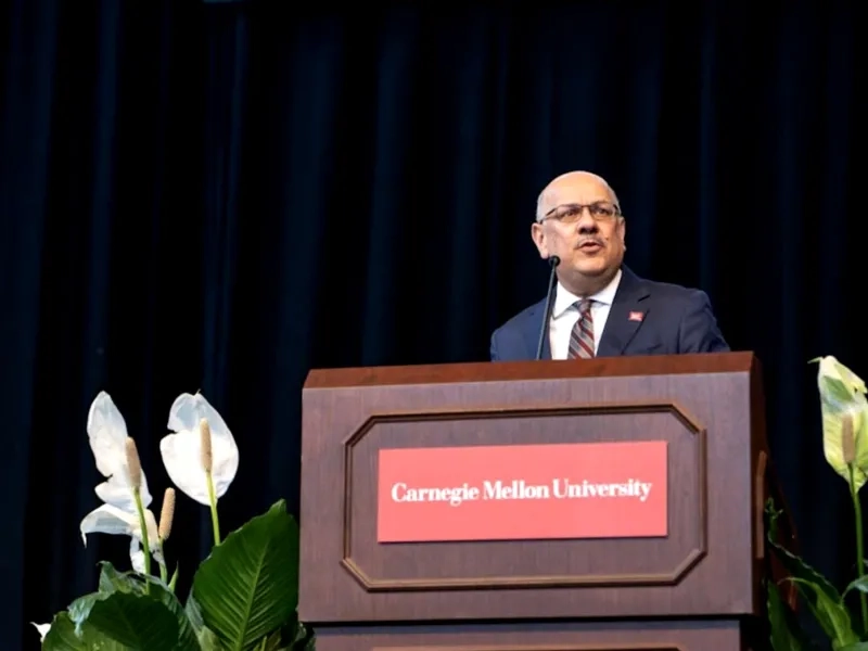 President Farnam Jahanian at a podium.