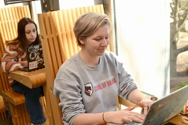 Students working at computers at individual tables