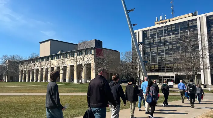 A group of people on the cut getting a tour of CMU. 